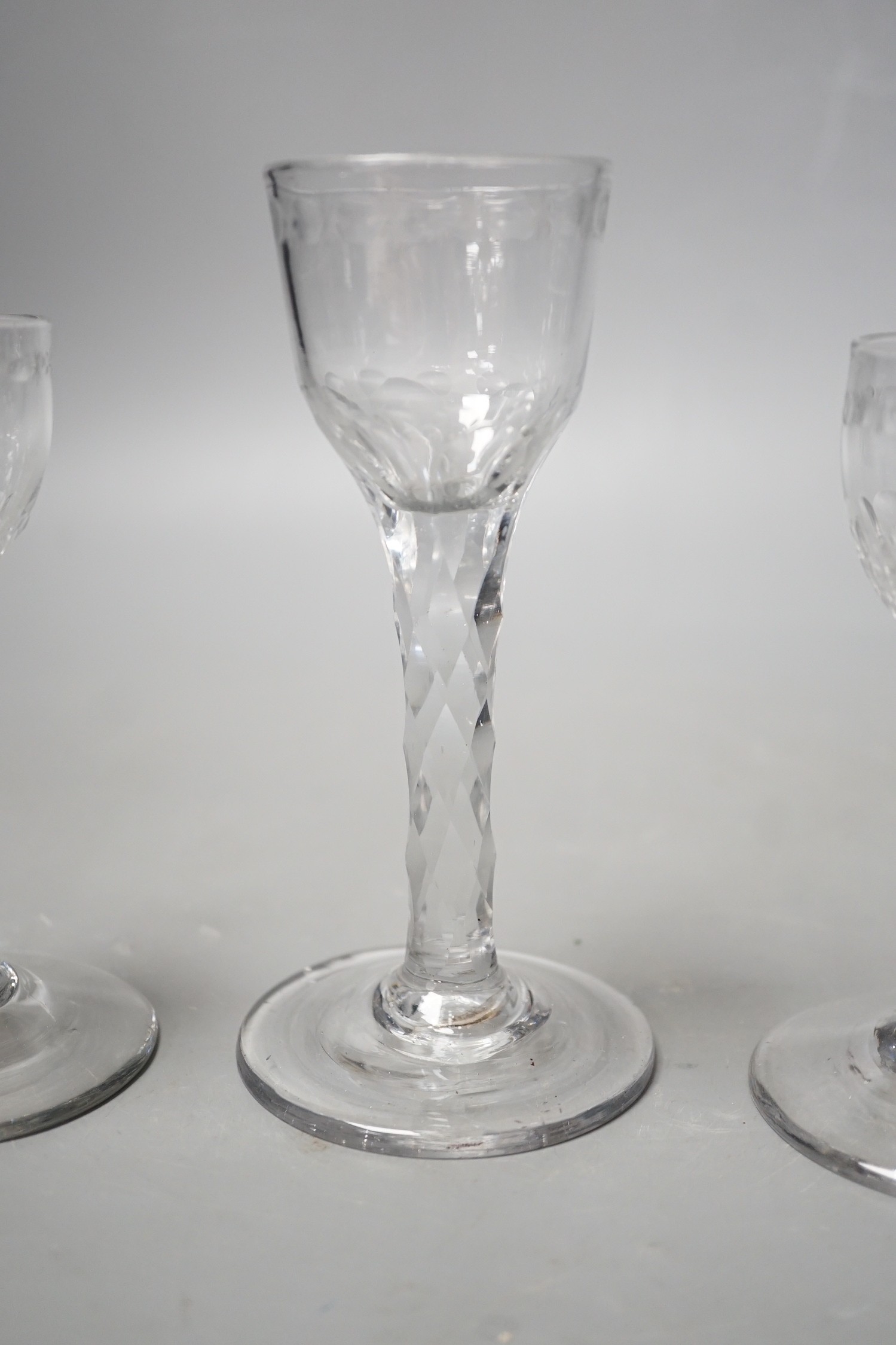 Three George III facet stem ‘OXO’ drinking glasses, tallest 15cms high